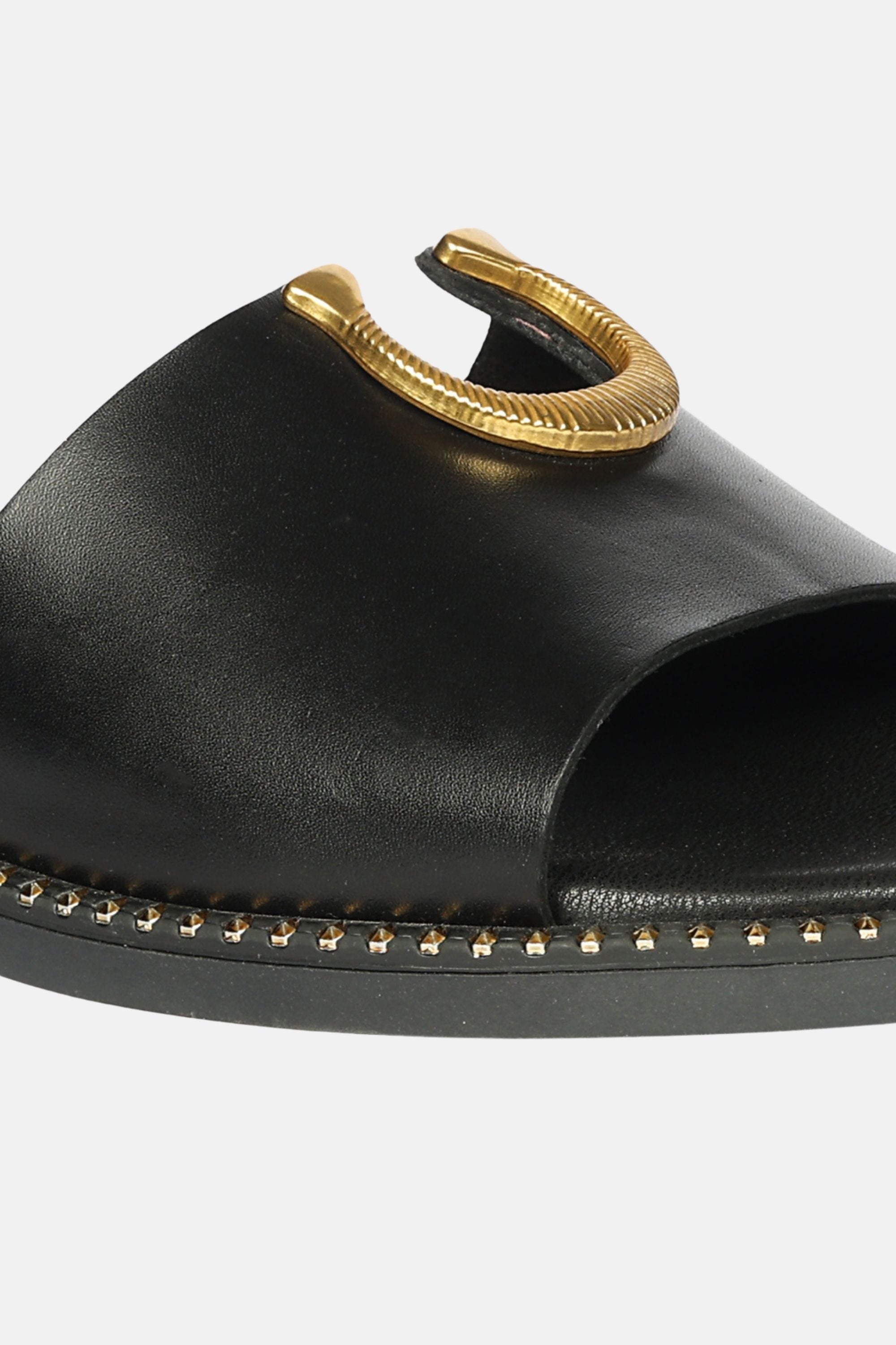 Acacia Flats by Vivi Blu showcasing a stylish slip-on design with elegant Gold Horse Shoe trim, crafted from premium black genuine leather.